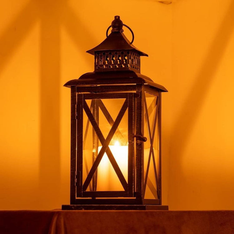 Vintage Black Candle Lantern Holder for Indoor Outdoor Decoration-Hansart-Hansart, Add a touch of vintage charm and warm ambiance to your space with this Rustic Black Metal Candle Lantern. Crafted from durable metal with clear glass panels, this lantern features an elegant cross-frame design and distressed finish, making it a perfect addition to both indoor and outdoor decor. Place a real or flameless LED candle inside to create a cozy glow on your patio, living room, garden, or during special events like w