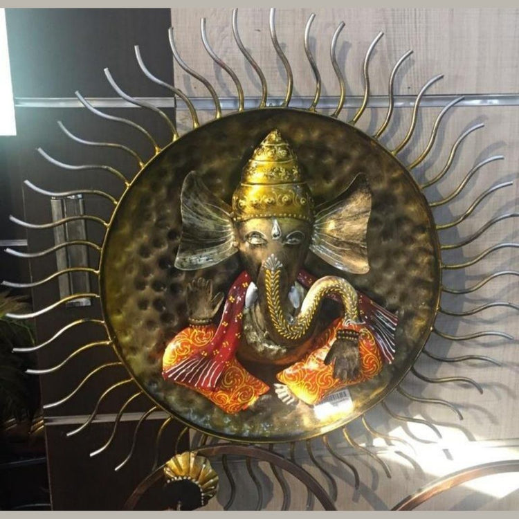 Enhance your home décor with this exquisite Handcrafted Metal Wall Hanging of Lord Ganesha with Sun Design. This beautiful artwork symbolizes positivity, wisdom, and prosperity, making it a perfect addition to your living space, pooja room, or office. The intricate detailing, vibrant colors, and stunning sunburst frame add a divine aura, making it a great gift for festive occasions, housewarmings, and spiritual celebrations. 35 X 35 Inches