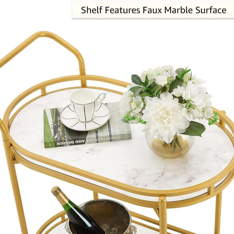 Gold serving cart with marble surface, flowers, and a bottle of wine.