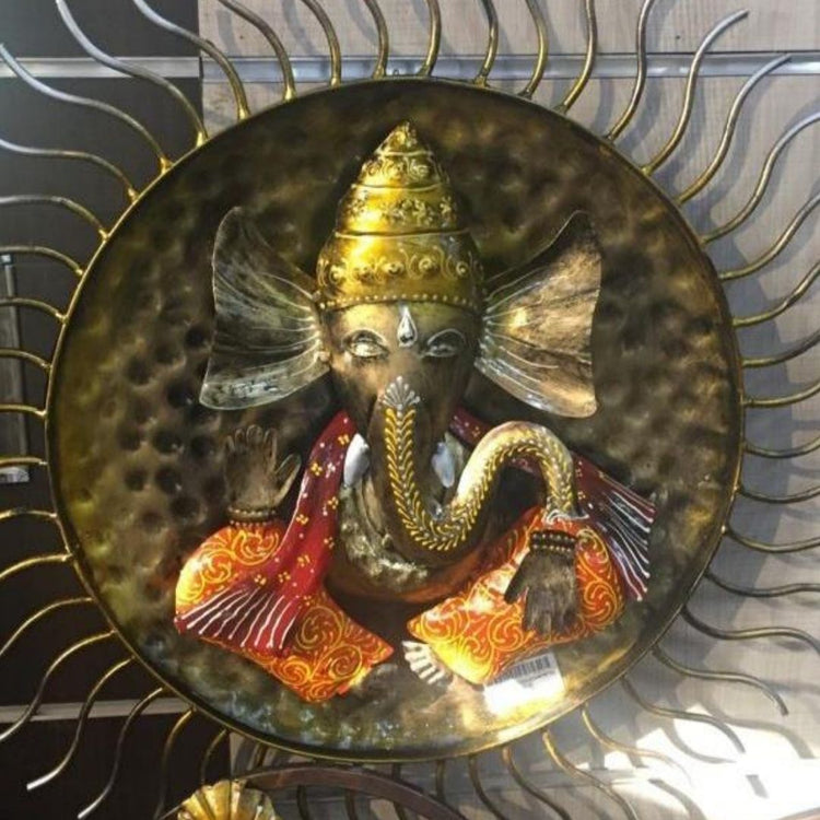 Enhance your home décor with this exquisite Handcrafted Metal Wall Hanging of Lord Ganesha with Sun Design. This beautiful artwork symbolizes positivity, wisdom, and prosperity, making it a perfect addition to your living space, pooja room, or office. The intricate detailing, vibrant colors, and stunning sunburst frame add a divine aura, making it a great gift for festive occasions, housewarmings, and spiritual celebrations. 35 X 35 Inches