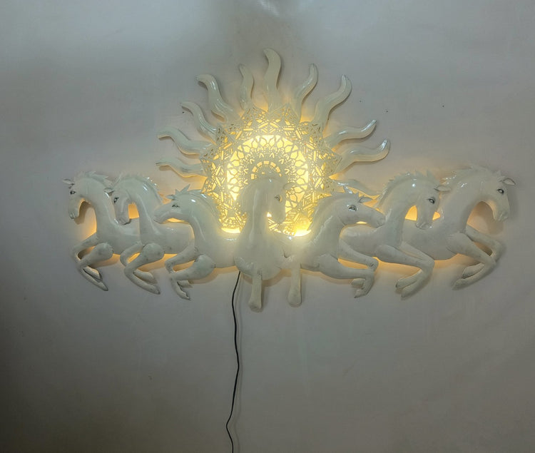 This Designer White metal wall art features a stunning depiction of 7 galloping horses against a warm sun backdrop. At 48 x 28 inches, it is sure to make a statement in any room. The integrated LED lights add a touch of modernity and ambiance. Perfect for any equestrian enthusiast. Size: 48 x 28 Inches. Made of High-Quality Iron Metal Anti-rust powder coating used for long lasting finish Hanging Mechanism included Horse wall decor with led lighting Perfect for your living room, bedroom, hall, office recep