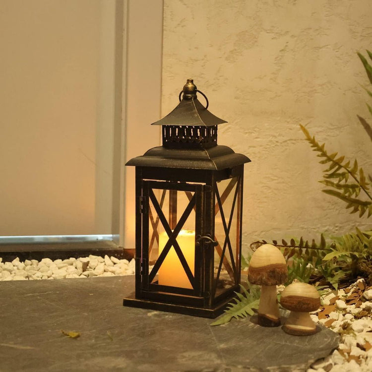 Vintage Black Candle Lantern Holder for Indoor Outdoor Decoration-Hansart-Hansart, Add a touch of vintage charm and warm ambiance to your space with this Rustic Black Metal Candle Lantern. Crafted from durable metal with clear glass panels, this lantern features an elegant cross-frame design and distressed finish, making it a perfect addition to both indoor and outdoor decor. Place a real or flameless LED candle inside to create a cozy glow on your patio, living room, garden, or during special events like w