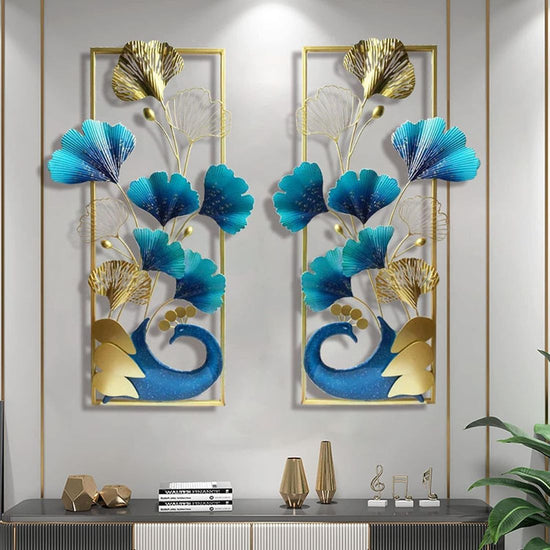 A set of two vertical frame metal wall art featuring a peacock and leaves with a gold and multicolor design.