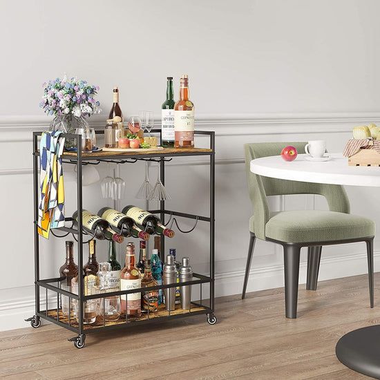 Bar cart with alcohol bottles and glasses in a dining room setting