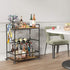 Bar cart with alcohol bottles and glasses in a dining room setting