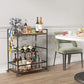 Bar cart with alcohol bottles and glasses in a dining room setting