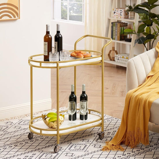 Gold bar cart with wine bottles and snacks in a living room setting