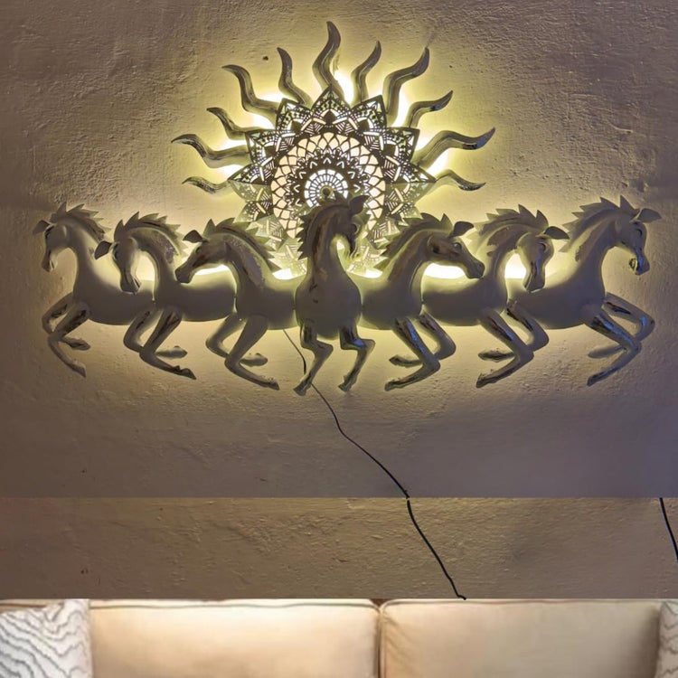 This Designer White metal wall art features a stunning depiction of 7 galloping horses against a warm sun backdrop. At 48 x 28 inches, it is sure to make a statement in any room. The integrated LED lights add a touch of modernity and ambiance. Perfect for any equestrian enthusiast.  Size: 48 x 28 Inches.  Made of High-Quality Iron Metal Anti-rust powder coating used for long lasting finish Hanging Mechanism included Horse wall decor with led lighting Perfect for your living room, bedroom, hall, office recep