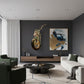 Modern living room with a motorcycle sculpture on the wall and abstract art.