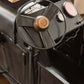 Close-up of a vintage-style suitcase with metallic accents