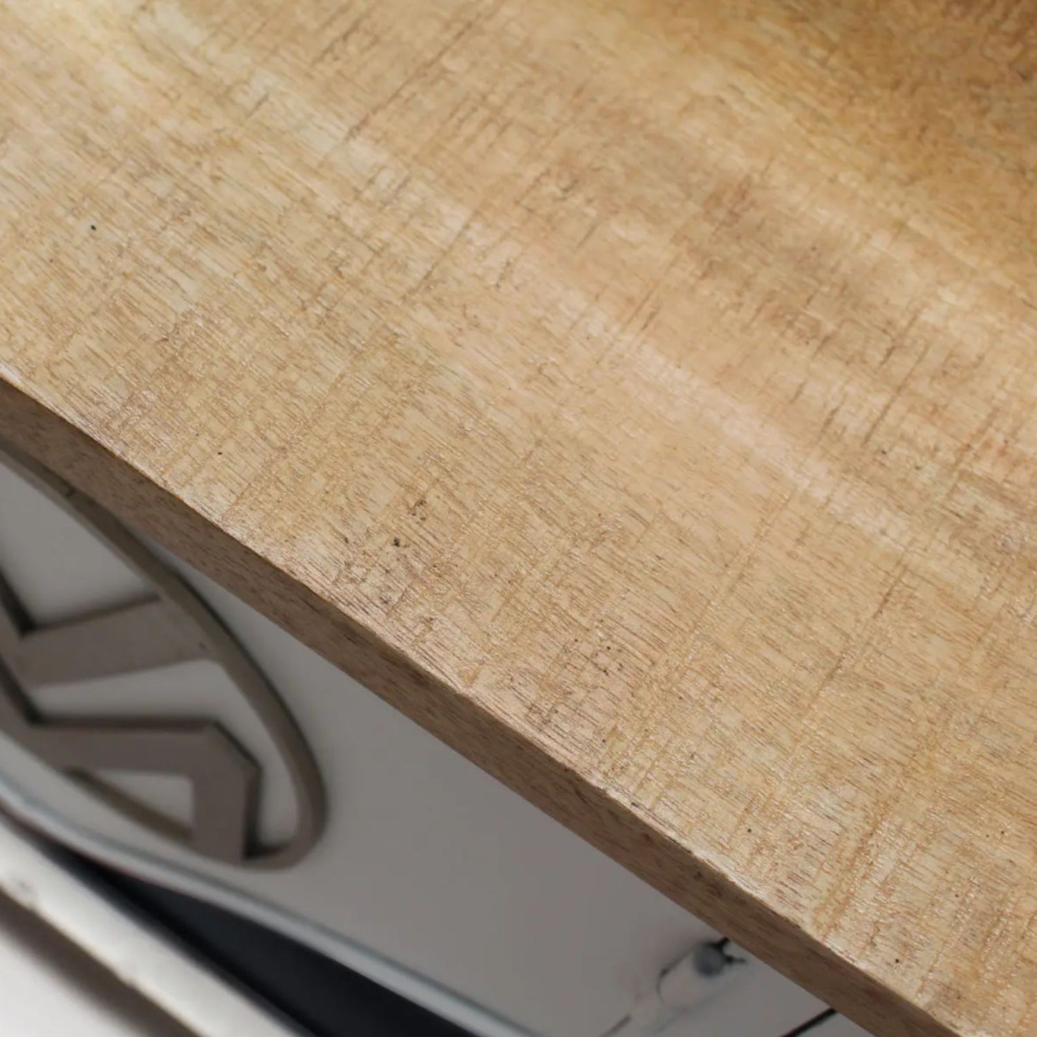 Close-up of a wooden surface with a metal handle