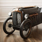 Vintage-style motorcycle on a wooden floor with a neutral background