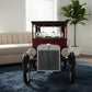 Vintage car-shaped bar cart with wine glasses in a living room setting