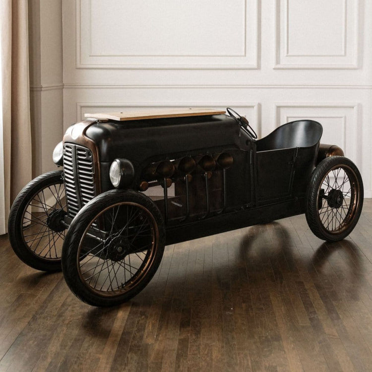 Vintage-style toy car on a wooden floor with a neutral background