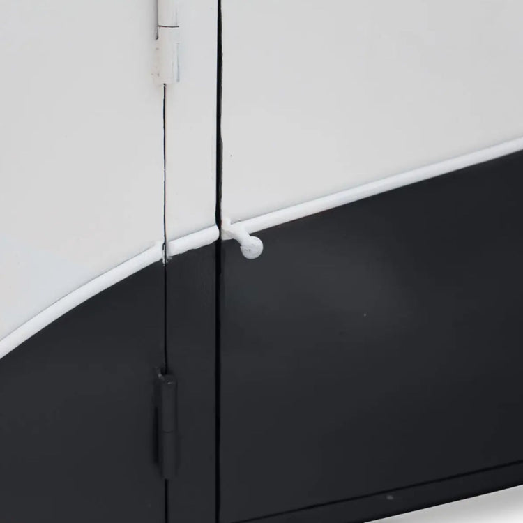 Close-up of a black and white door with a hinge