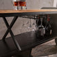 Industrial airplane-engine style bar cart with propeller decoration and dual shelves, featuring wooden tabletop, black metal frame, large rubberized wheels, hanging wine-glass rack and storage for bottles, set in a modern living-room environment