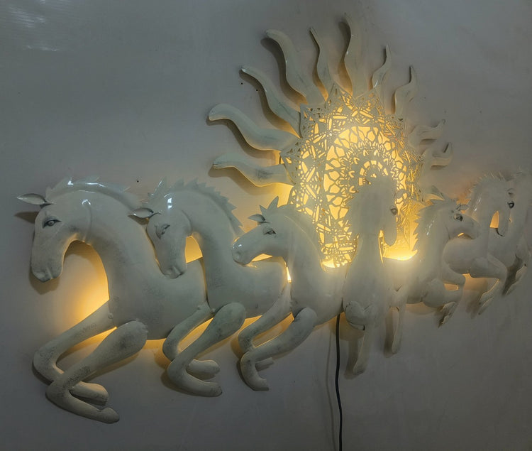 This Designer White metal wall art features a stunning depiction of 7 galloping horses against a warm sun backdrop. At 48 x 28 inches, it is sure to make a statement in any room. The integrated LED lights add a touch of modernity and ambiance. Perfect for any equestrian enthusiast.  Size: 48 x 28 Inches.  Made of High-Quality Iron Metal Anti-rust powder coating used for long lasting finish Hanging Mechanism included Horse wall decor with led lighting Perfect for your living room, bedroom, hall, office recep