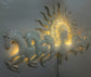 This Designer White metal wall art features a stunning depiction of 7 galloping horses against a warm sun backdrop. At 48 x 28 inches, it is sure to make a statement in any room. The integrated LED lights add a touch of modernity and ambiance. Perfect for any equestrian enthusiast.  Size: 48 x 28 Inches.  Made of High-Quality Iron Metal Anti-rust powder coating used for long lasting finish Hanging Mechanism included Horse wall decor with led lighting Perfect for your living room, bedroom, hall, office recep