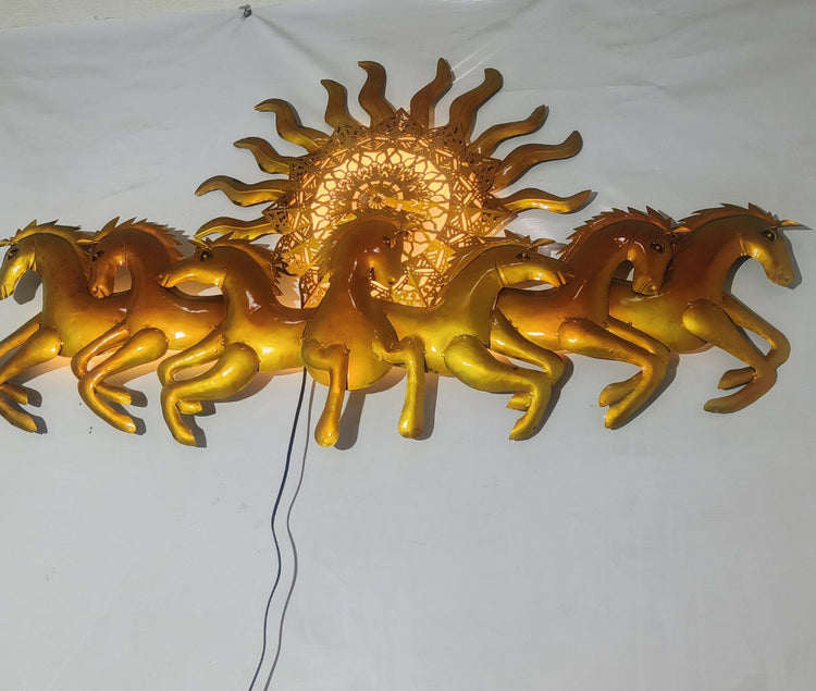 This Designer Gold metal wall art features a stunning depiction of 7 galloping horses against a warm sun backdrop. At 48 x 28 inches, it is sure to make a statement in any room. The integrated LED lights add a touch of modernity and ambiance. Perfect for any equestrian enthusiast.  Size: 48 x 28 Inches.  Made of High-Quality Iron Metal Anti-rust powder coating used for long lasting finish Hanging Mechanism included Horse wall decor with led lighting Perfect for your living room, bedroom, hall, office recept