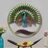 Decorative wall art of a peacock with a colorful fan on a gray wall.