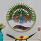 Decorative wall art of a peacock with a colorful fan on a gray wall.