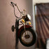 HANSART, Bring a bold and nostalgic touch to your space with this Vintage Motorcycle Front Wall Decor. Designed to replicate the front of a classic motorcycle, this unique wall art piece features realistic details including a metal handlebar, headlight, and tire. The industrial retro finish and authentic styling make it a perfect statement piece for garages, cafes, man caves, or any space in need of a rugged, adventurous vibe.