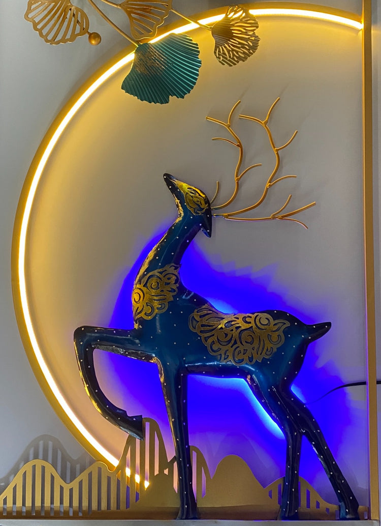 Decorative wall art with a deer silhouette against a gold and blue background