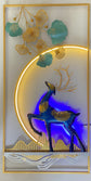 Decorative wall art with a blue deer and colorful leaves in a modern interior setting
